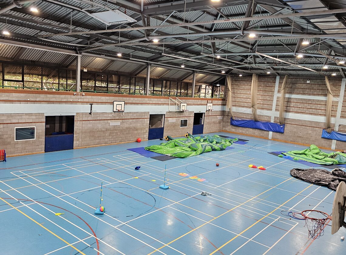 Large indoor sports hall set up for camp activities