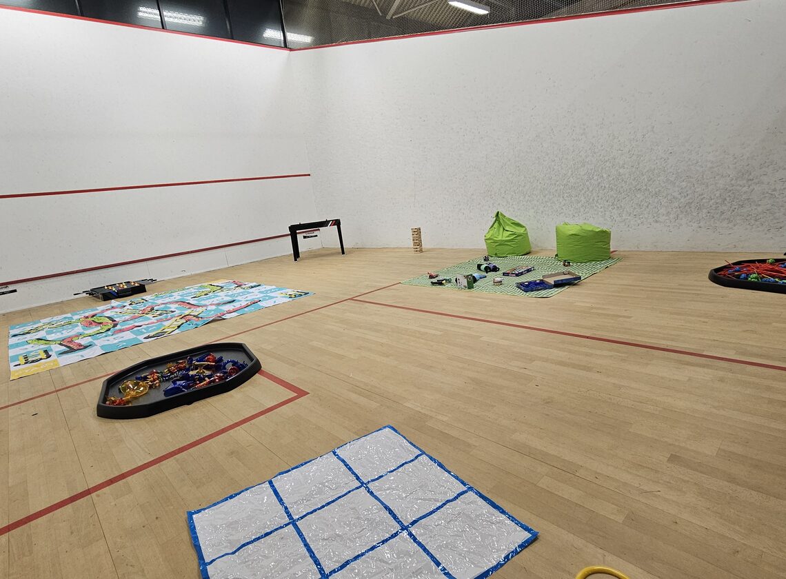 Squash court set up as a quiet games and craft space