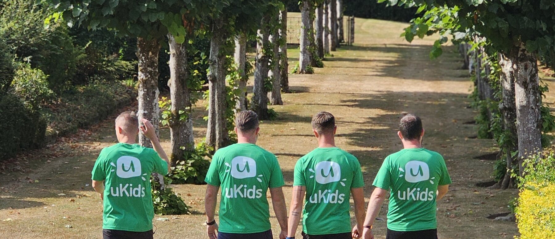 uKids team walking through tree-lined school grounds