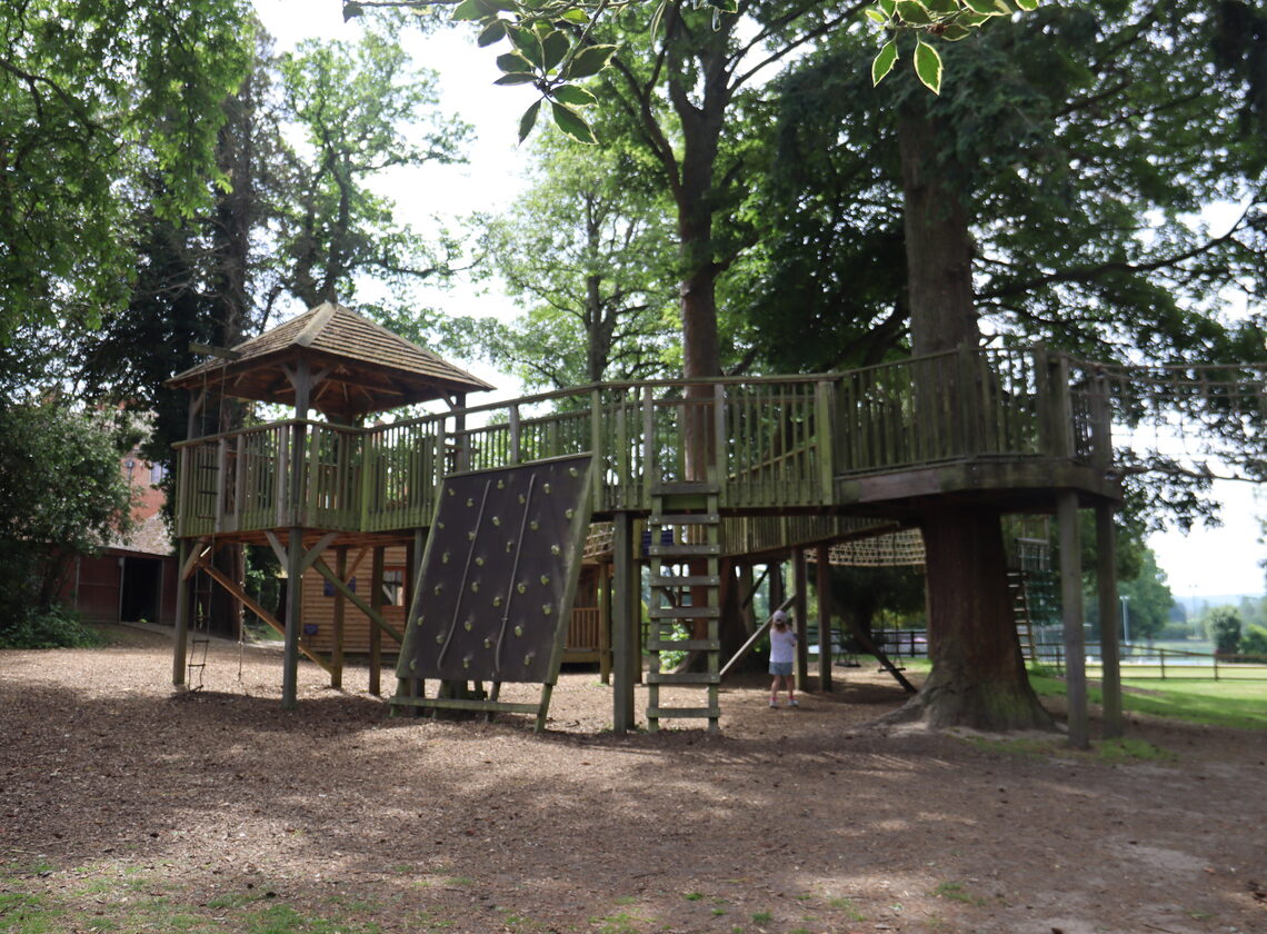 Wooden treehouse and climbing frame in the grounds