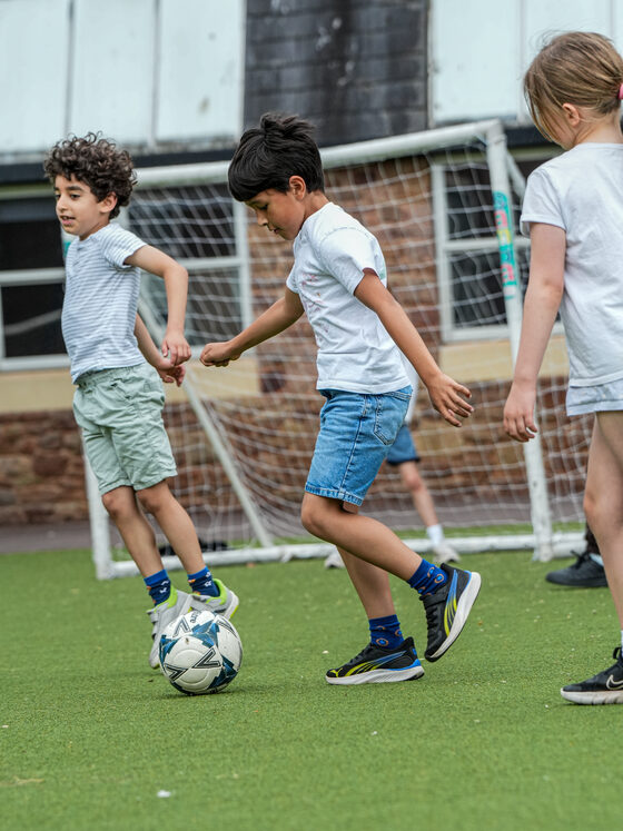 Children playing football on the astro pitch