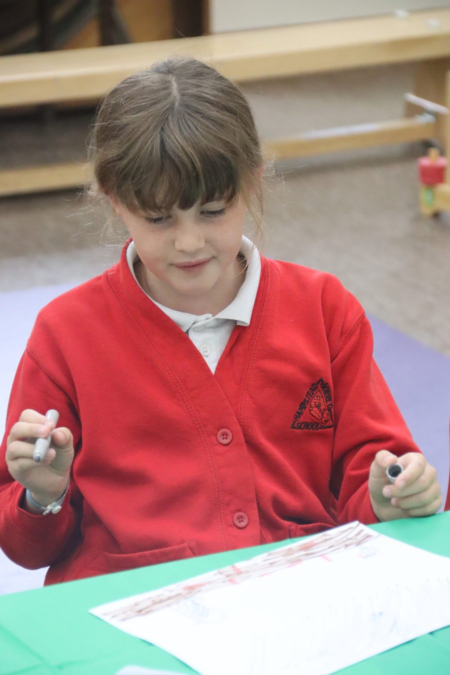 A child drawing at uKids after-school club at Hampstead Norreys