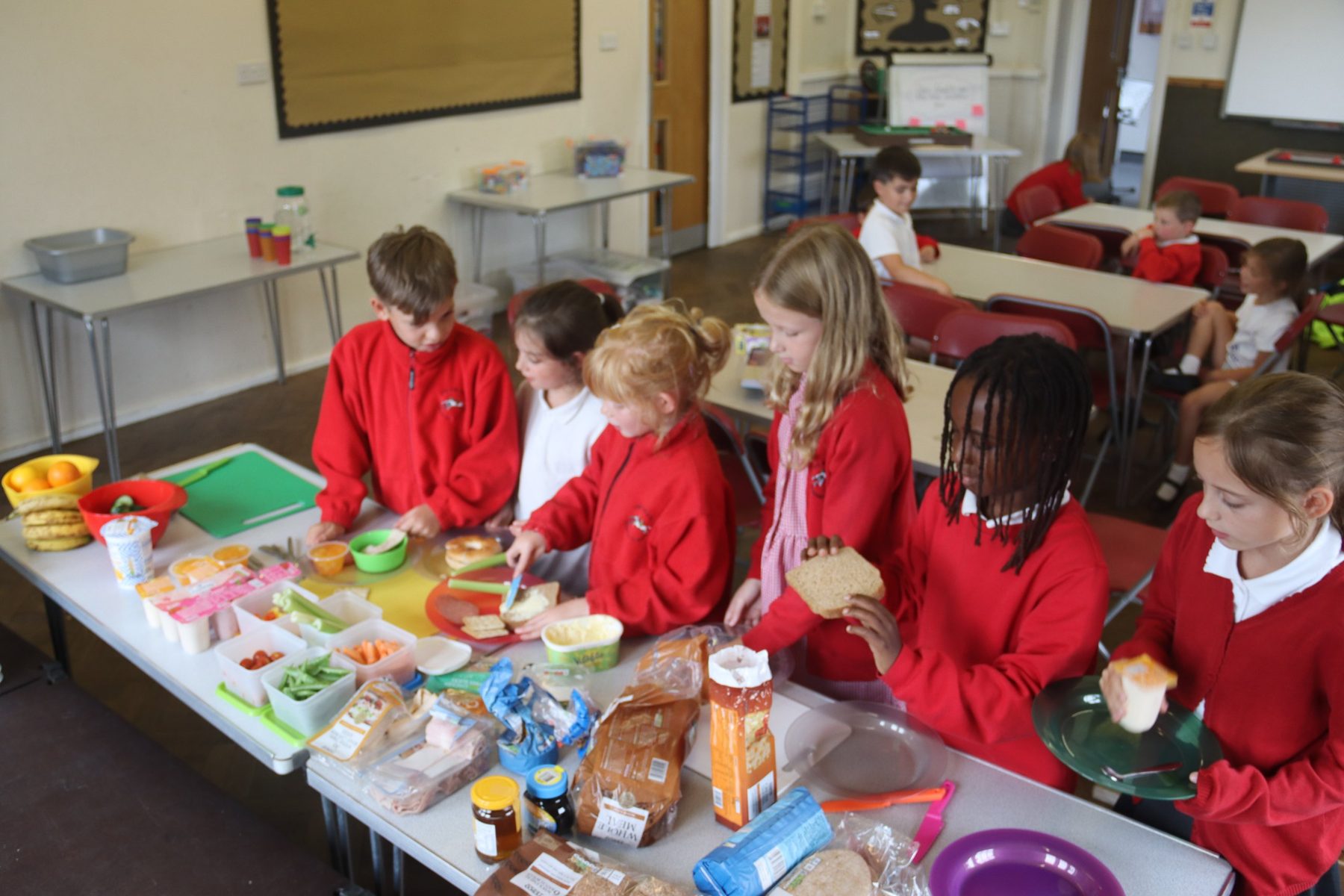 Children making their own snack at uKids after-school club at The Ilsleys
