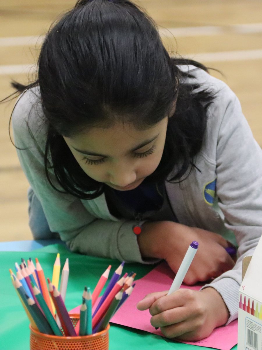 A child colouring at uKids club at Wheatfield