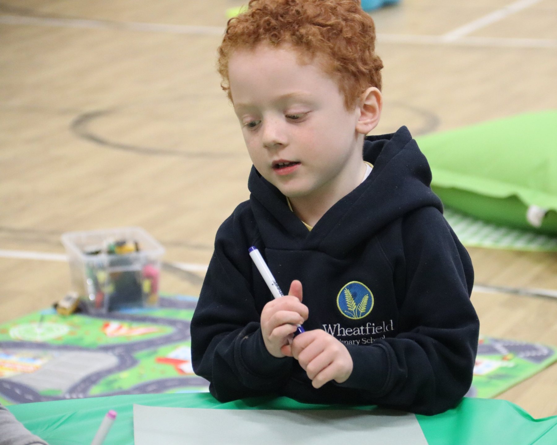 A child drawing at uKids club at Wheatfield