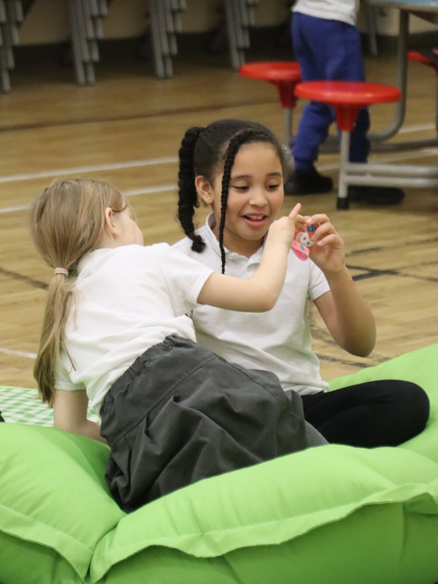 Two children playing on a beanbag at uKids club at Windmill