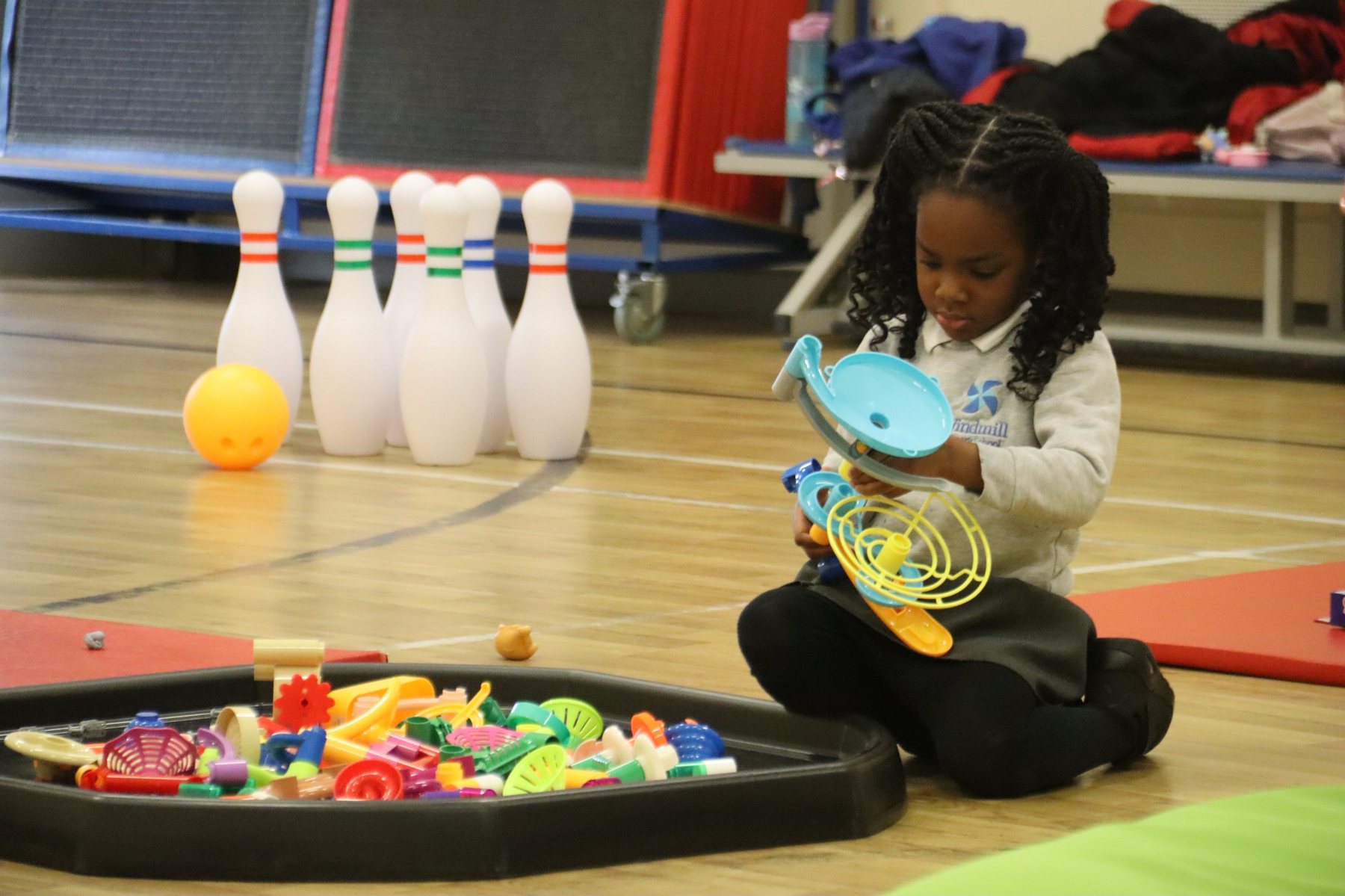 A child building a marble run at uKids club at Windmill